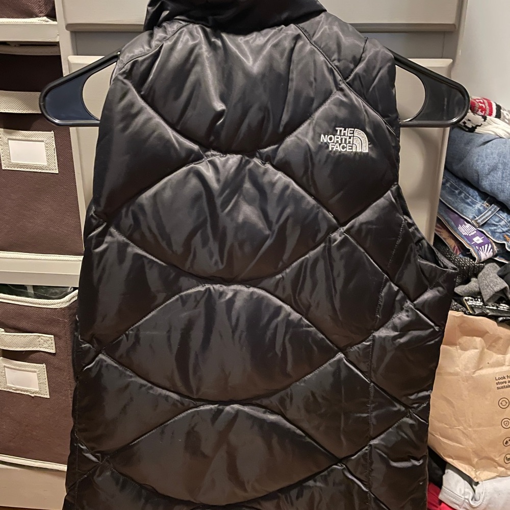 The North Face black quilted bubble vest. Down. Looks brand new, hardly worn.